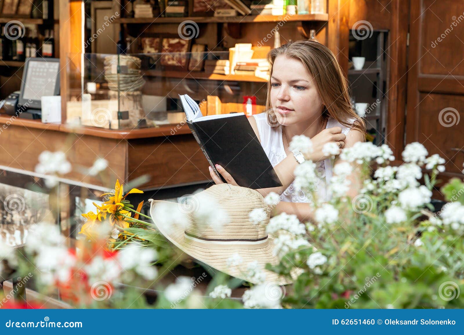 Smiling Girl Sitting at Summer Terrace and Reading Book Stock Photo ...