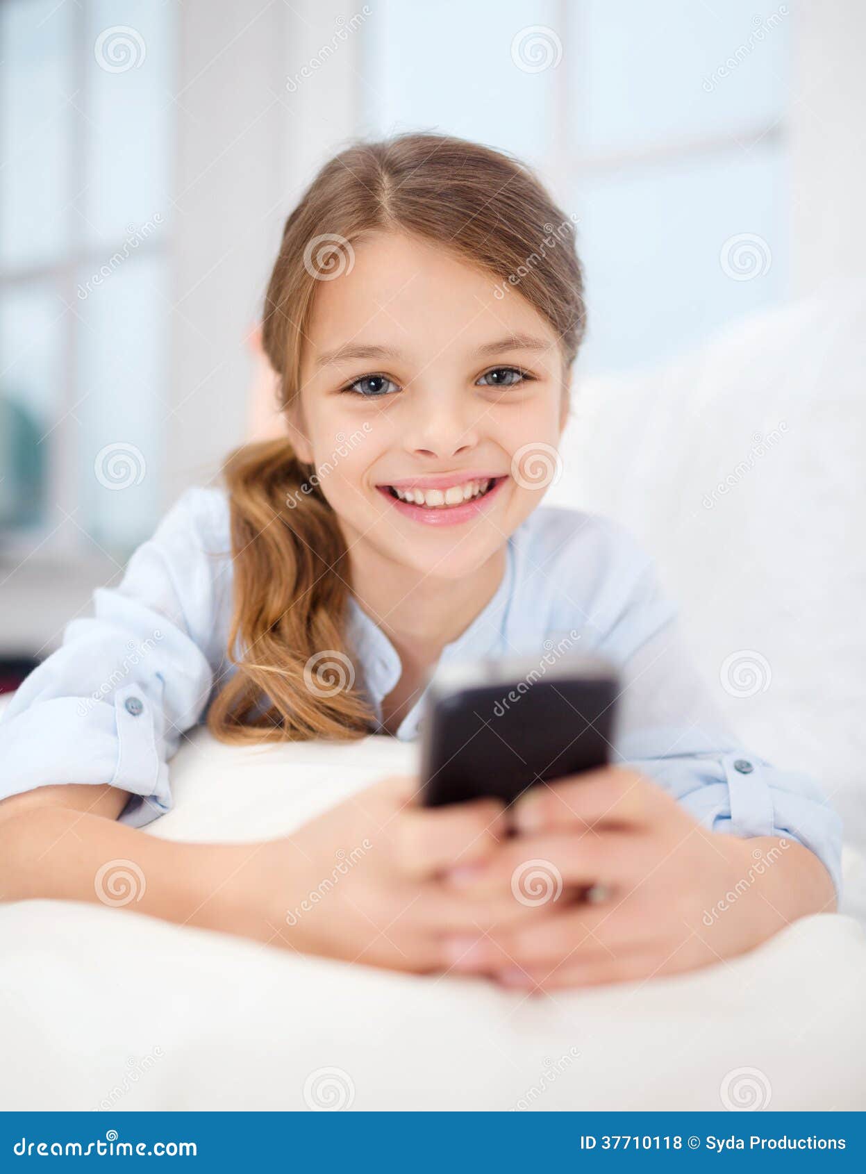 Smiling With Smartphone At Home Smiling With Smartphone At Home Stock Photo Image