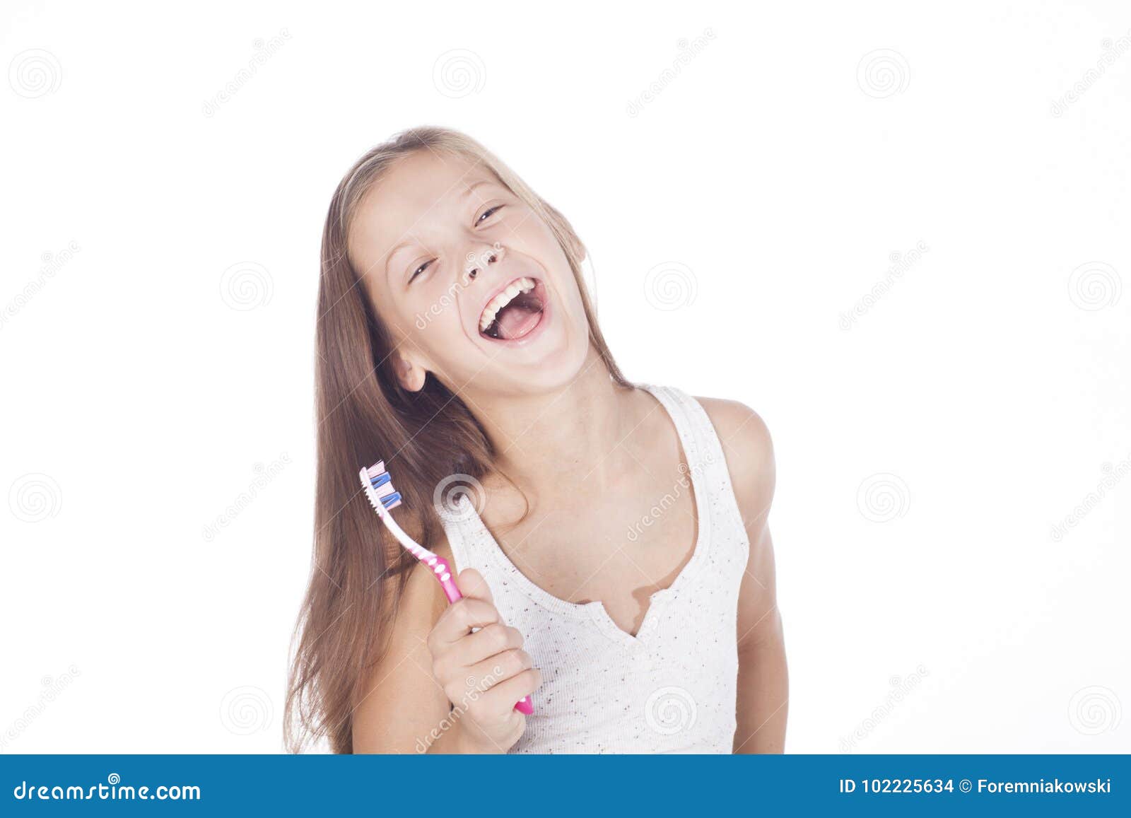 young girl is brushing her teeth.