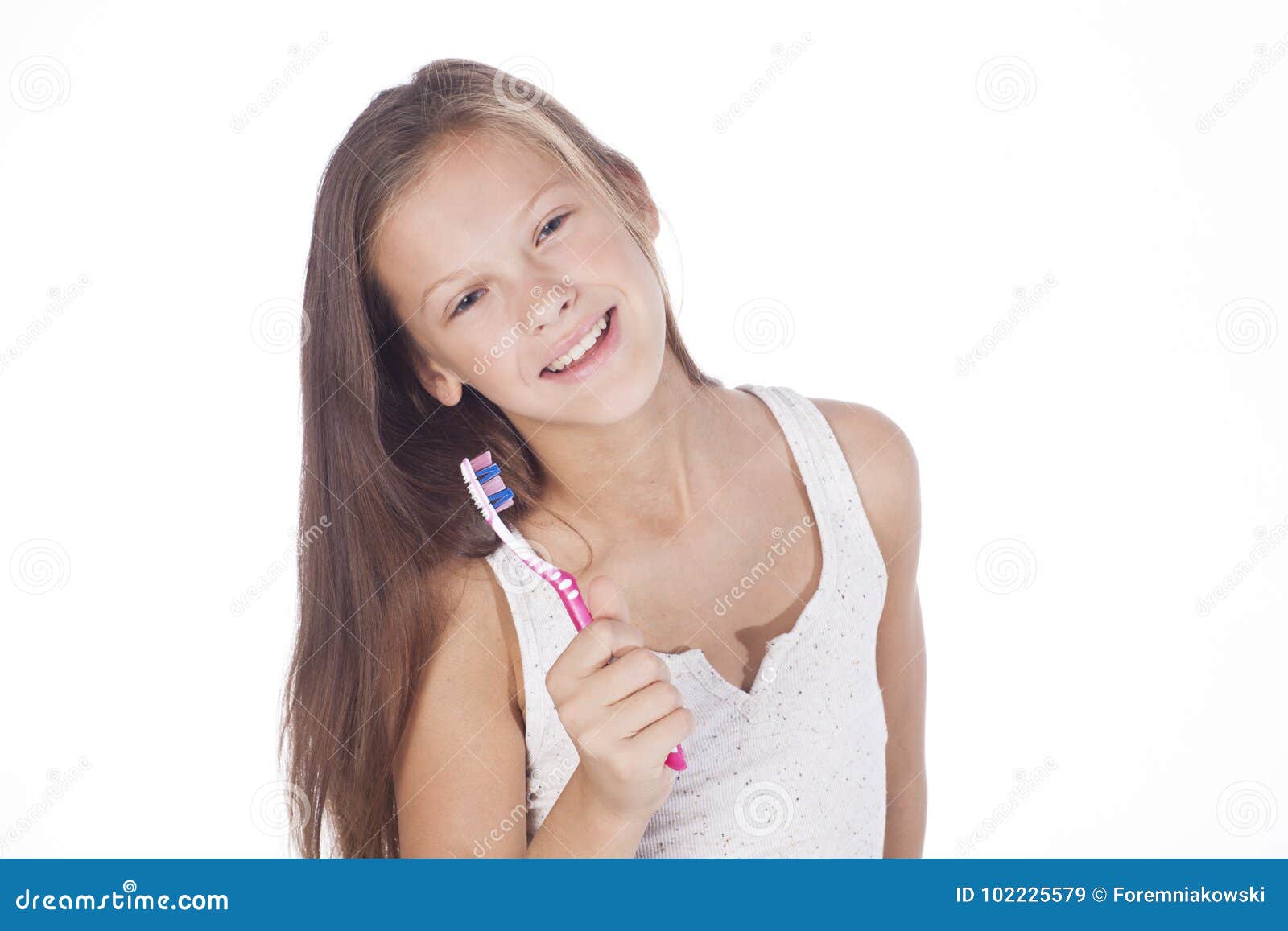 young girl is brushing her teeth.