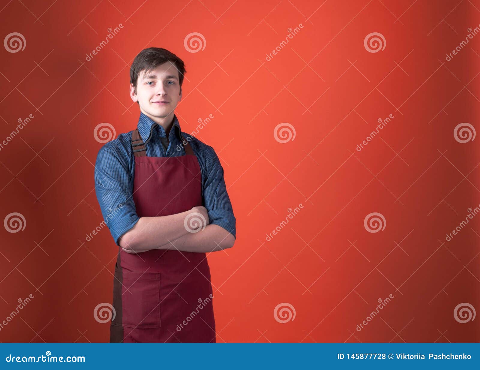 Smiling Handsome Barista With Dark Hair In Burgundy Apron
