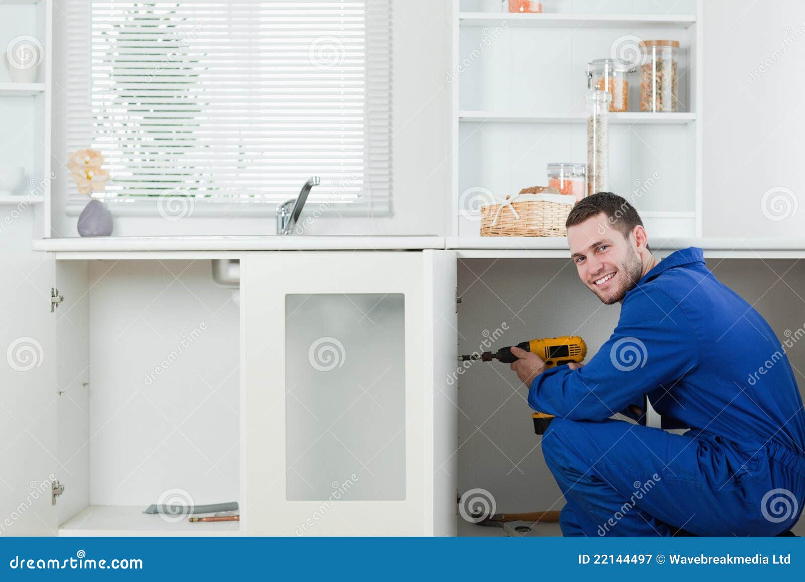 smiling handyman fixing a door
