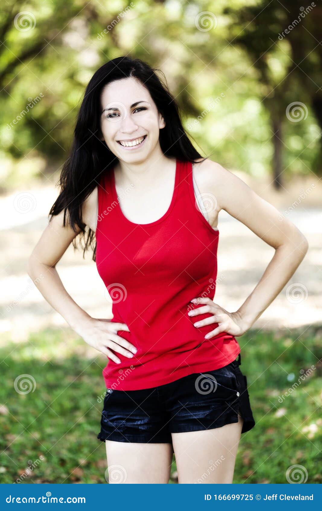Smiling Hispanic Teen Woman Outdoors Red Top And Shorts