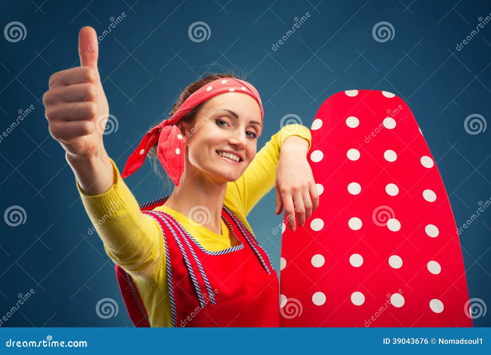 Happy smiling housewife with ironing-board isolated on blue