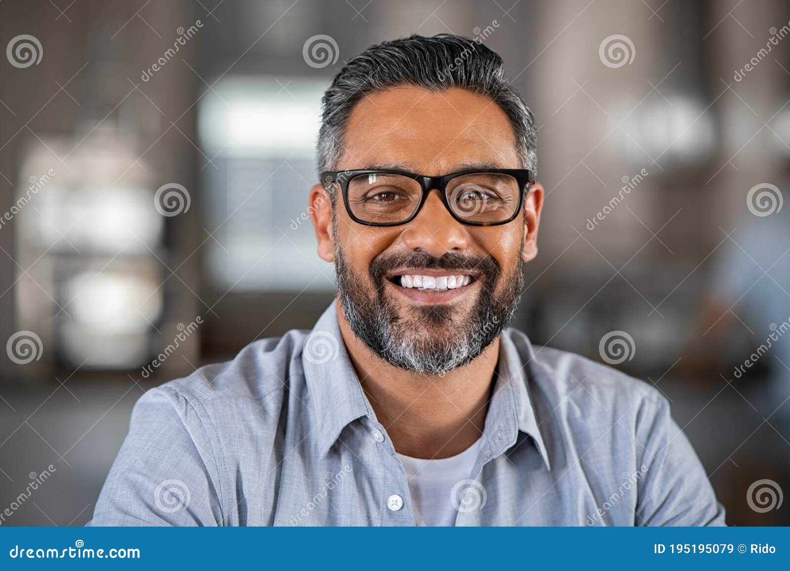 smiling indian man looking at camera