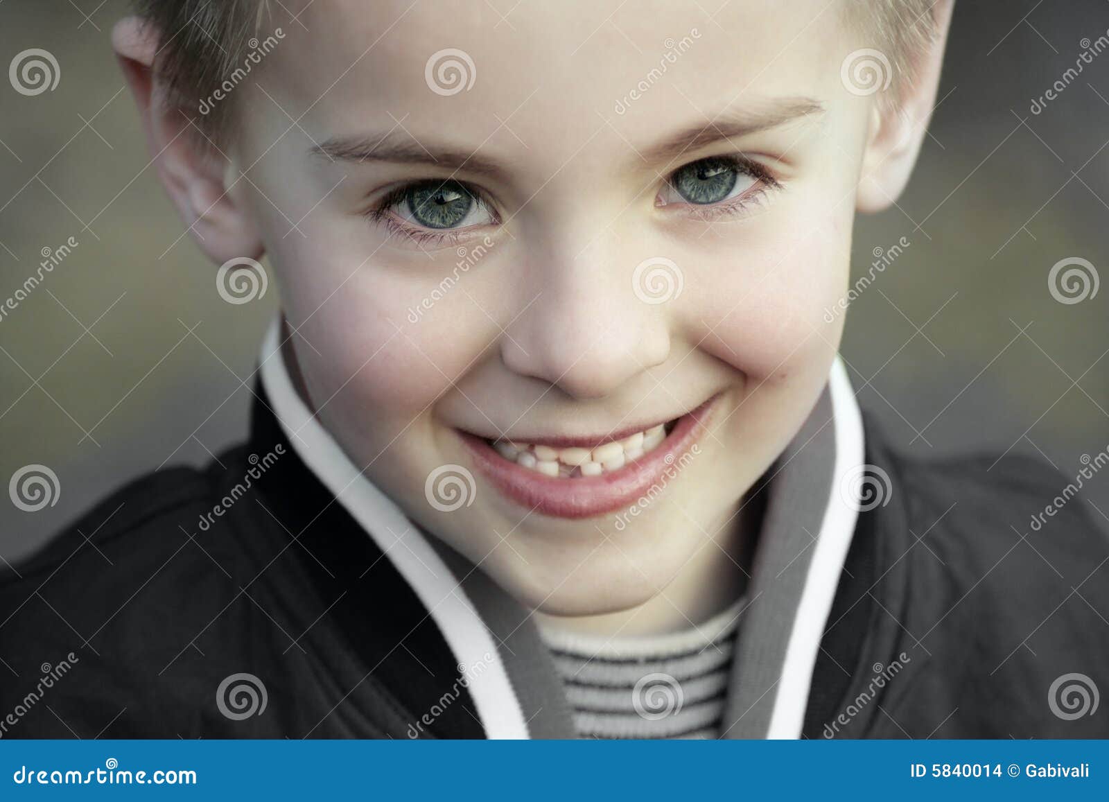 smiling innocent kid with perfect blue eyes