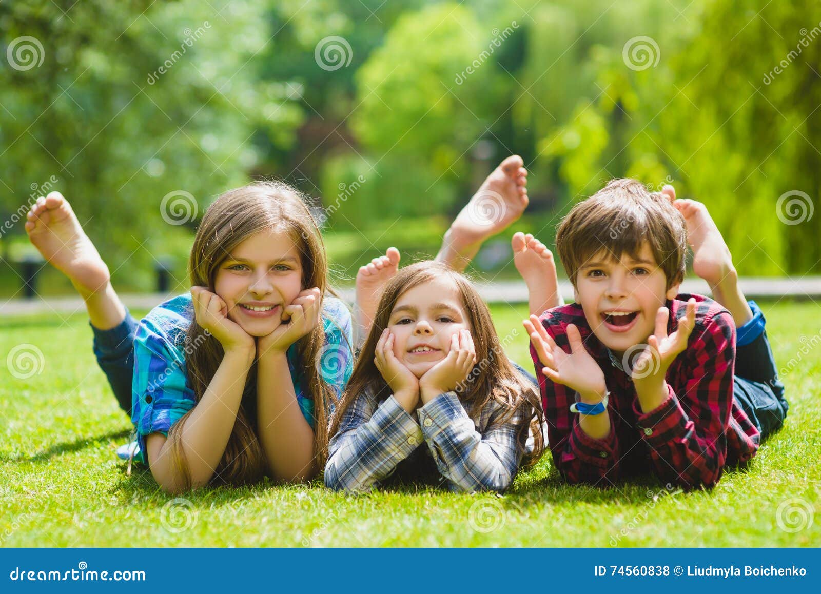 Smiling Kids Having Fun at Grass. Children Playing Outdoors in Summer