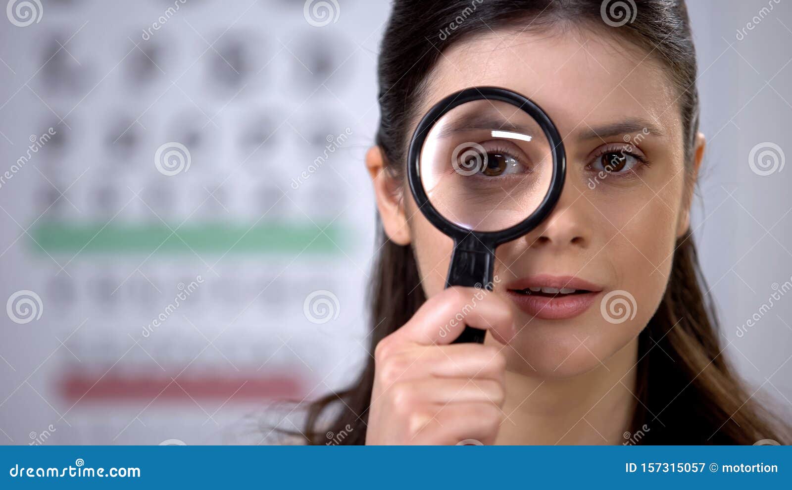 smiling lady looking through magnifying glass, eye cornea genetics, treatment