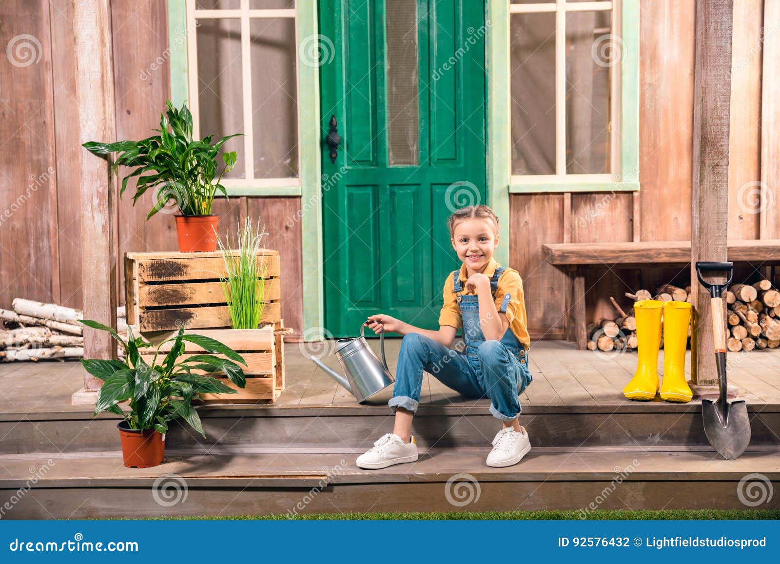 Little Girl In A Hat Sits On The Porch Of An Old Wooden House Stock Image - Image of beautiful 