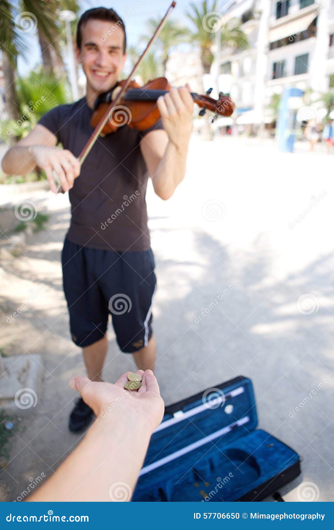 smiling male busker playing violin