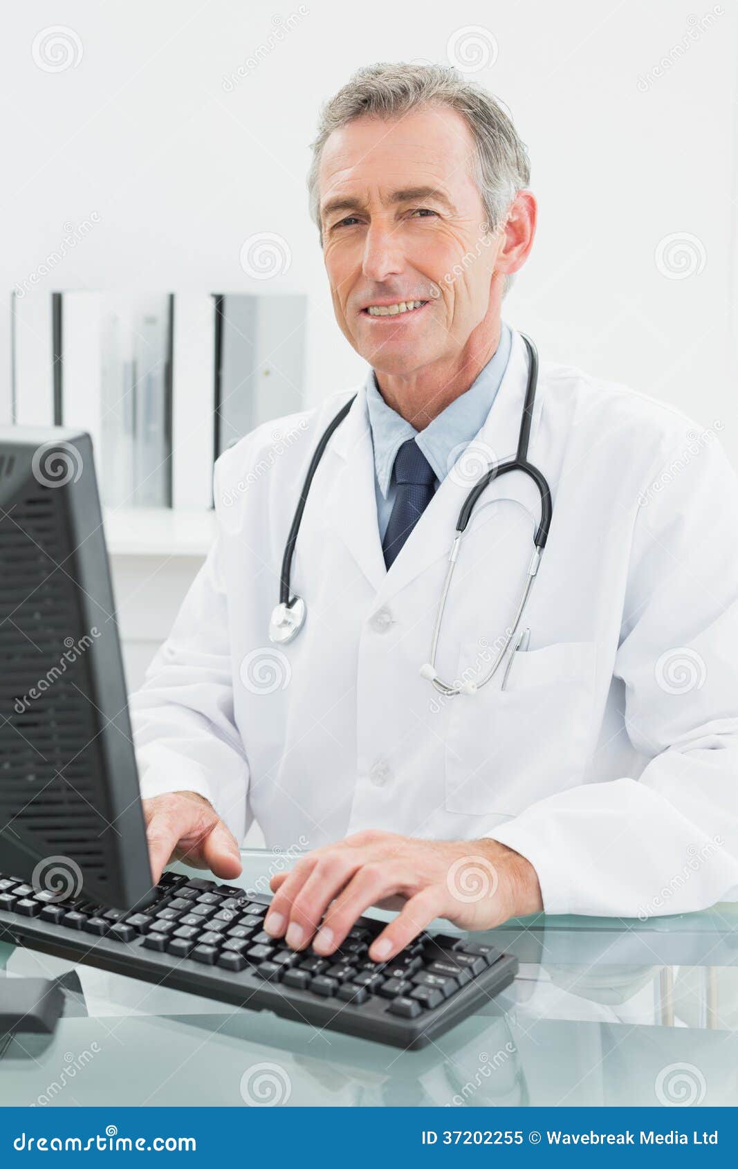 Smiling Male Doctor Using Computer at Office Stock Image Image of coat, indoors 37202255