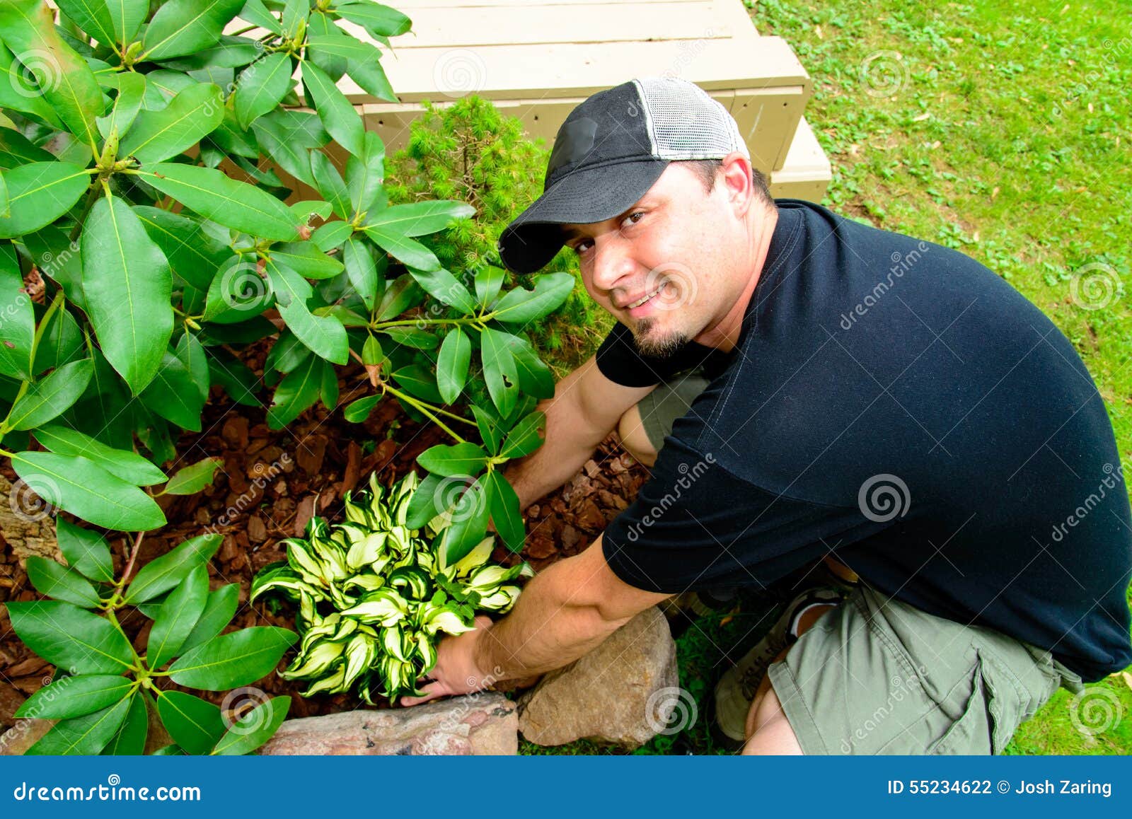 smiling man planting and landscaping