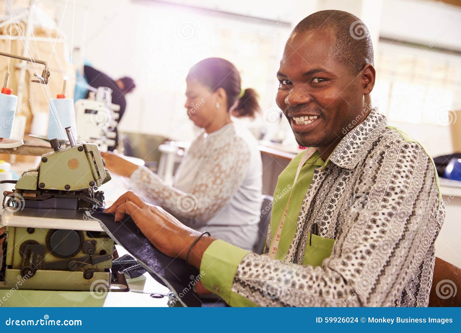 Smiling Man Sewing at a Community South Africa Stock Photo