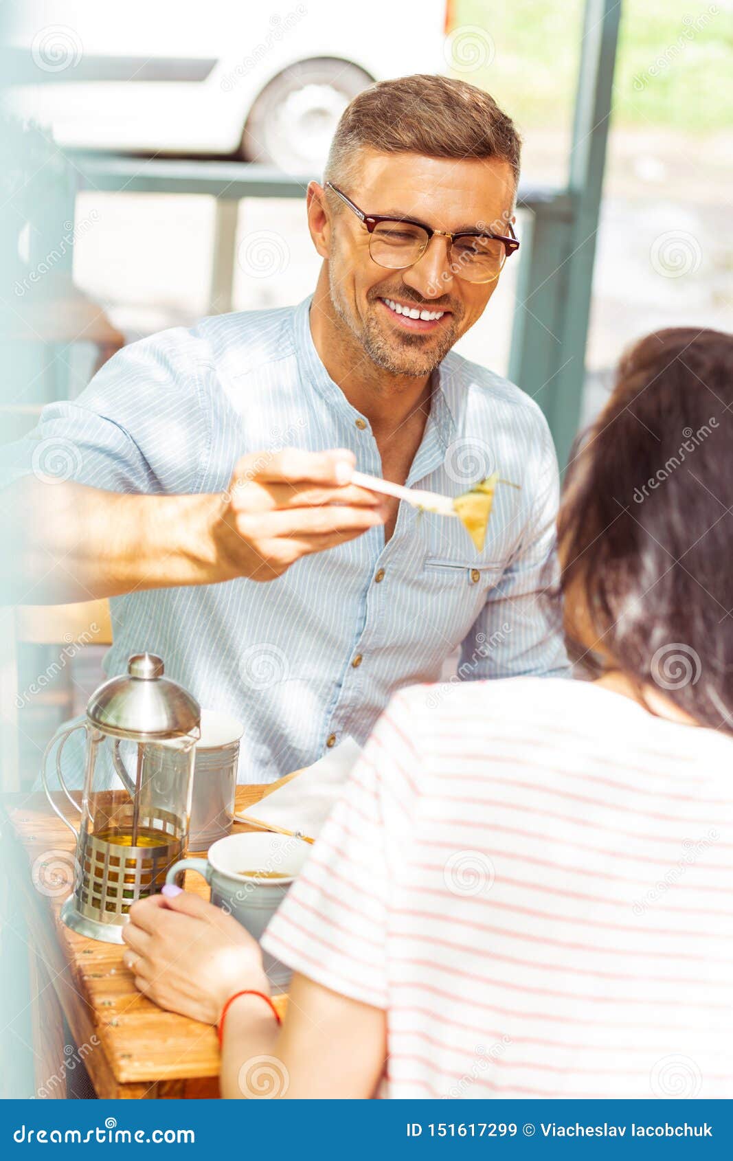 Smiling Man Sharing His Food with His Wife. Stock Image Image of