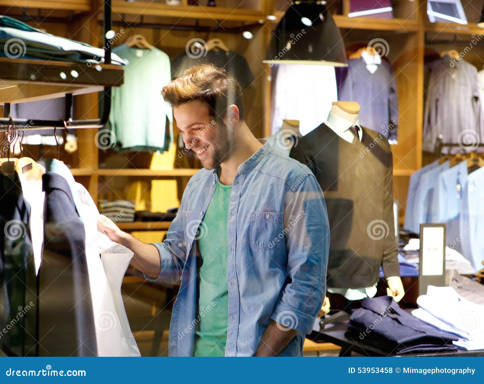 smiling man shopping for clothes at clothing store