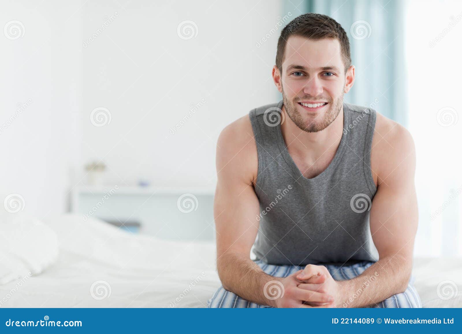 Smiling Man Sitting on His Bed Stock Image - Image of 1819, beauty ...