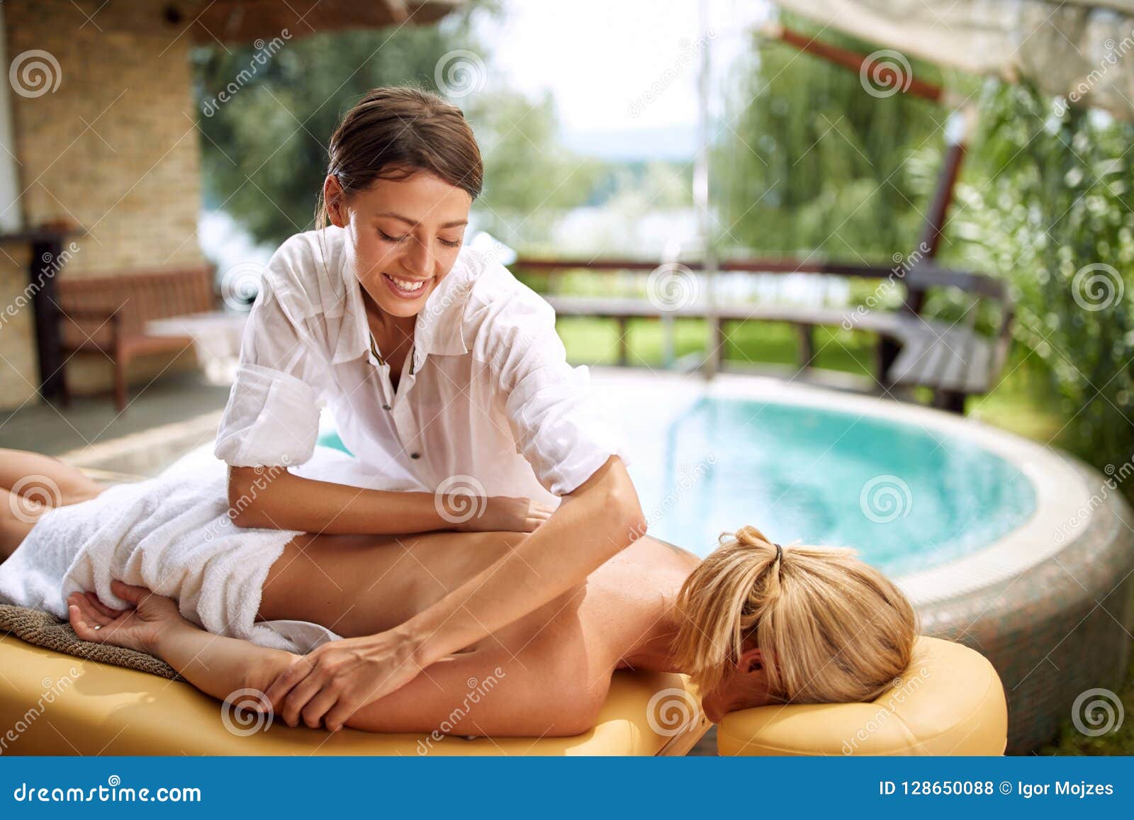 massage therapist doing a back massage on outdoor