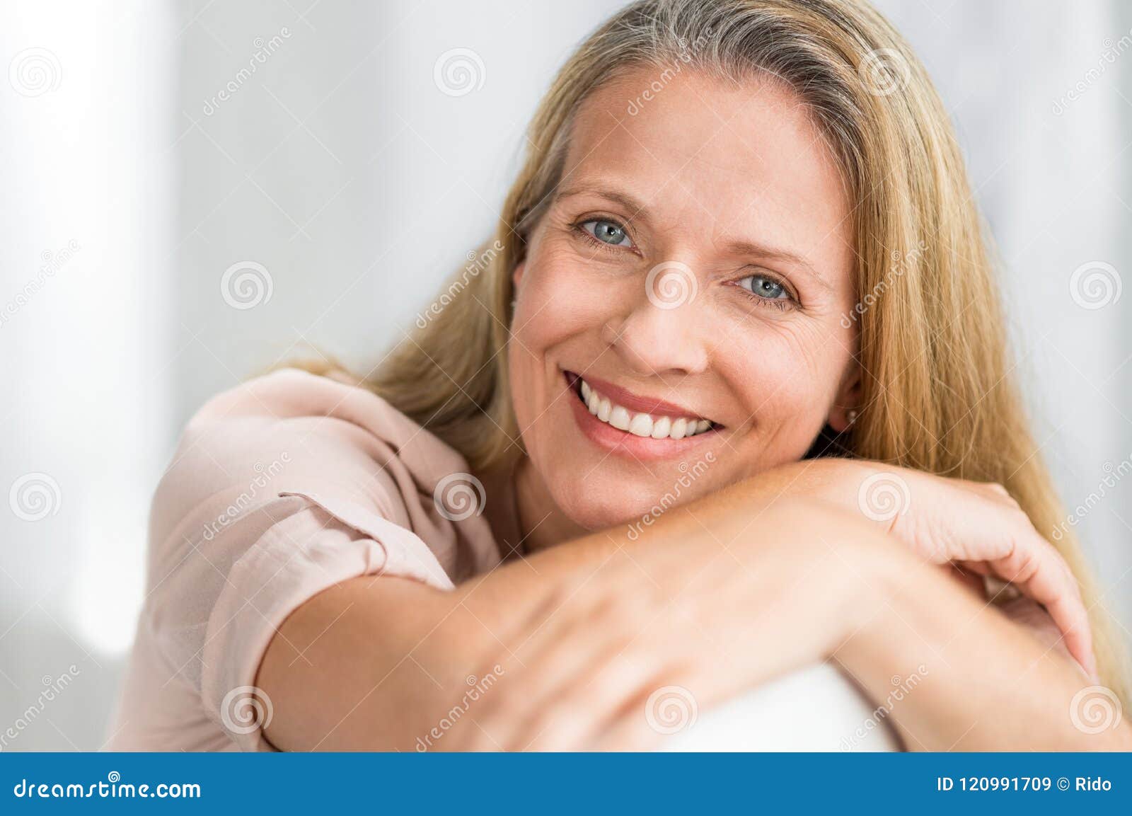 smiling mature woman on couch
