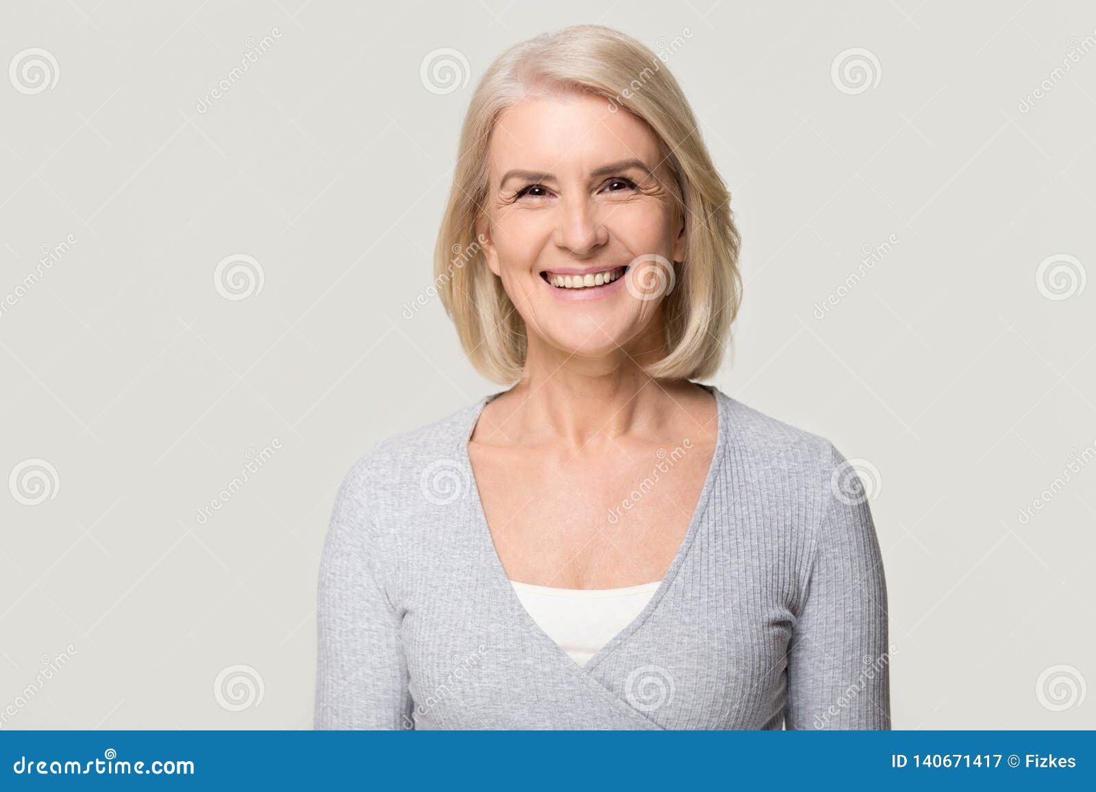 Senior woman isolated. Lady smiling on white background 
