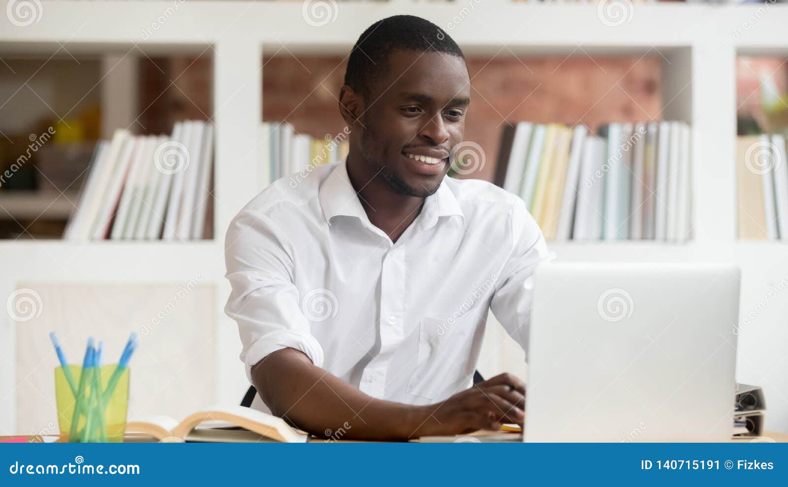 happy black male student using apps study online on computer
