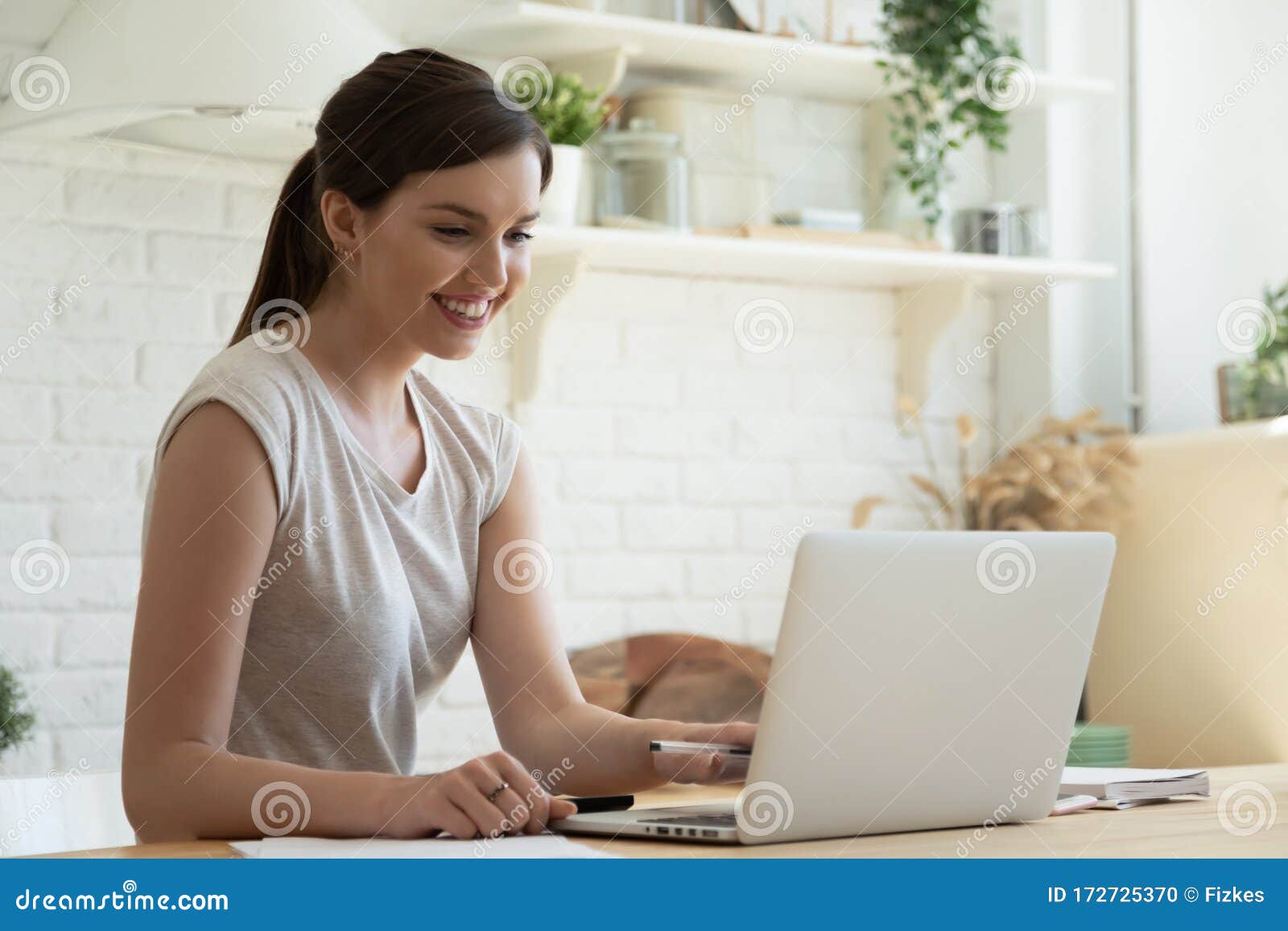 smiling millennial girl watch webinar on laptop