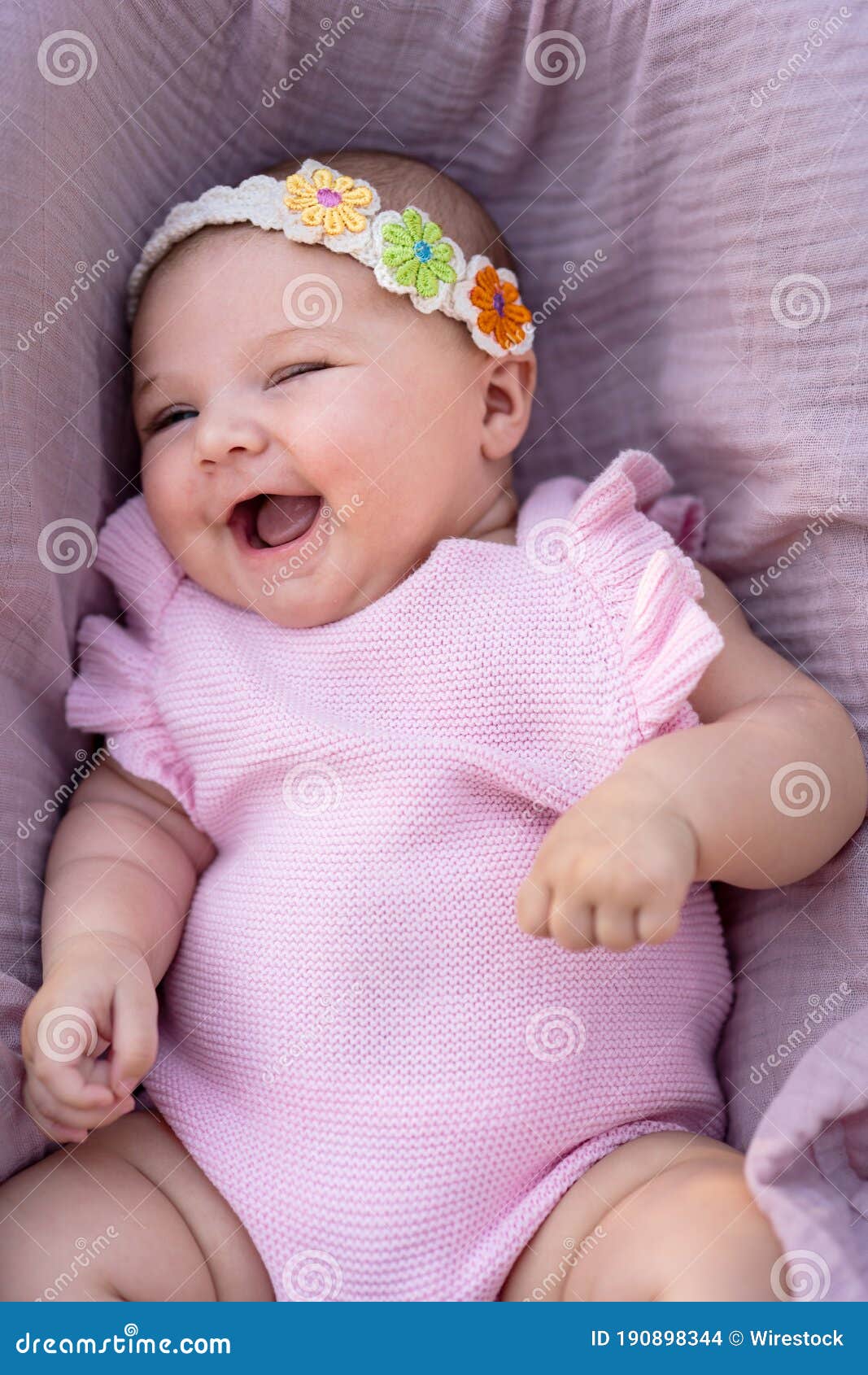 Smiling Newborn Baby Girl with Pink Clothes and Knitted Head ...