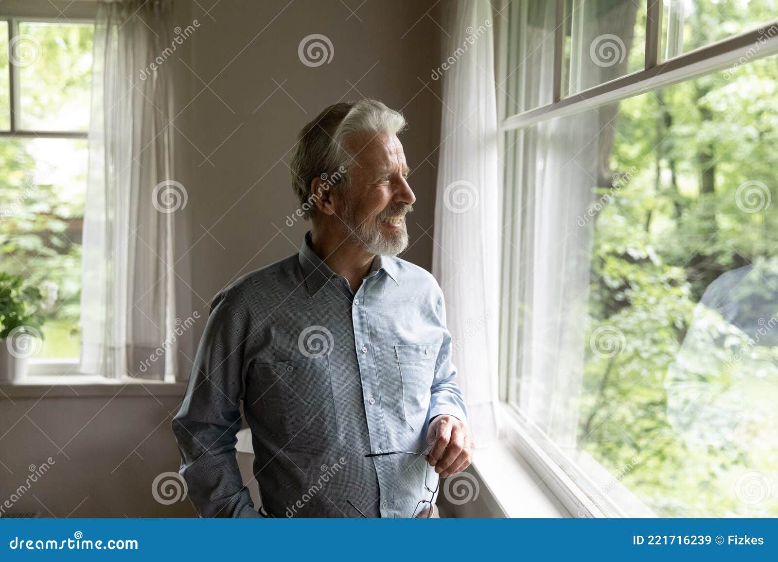 smiling old man look in window enjoy healthy maturity