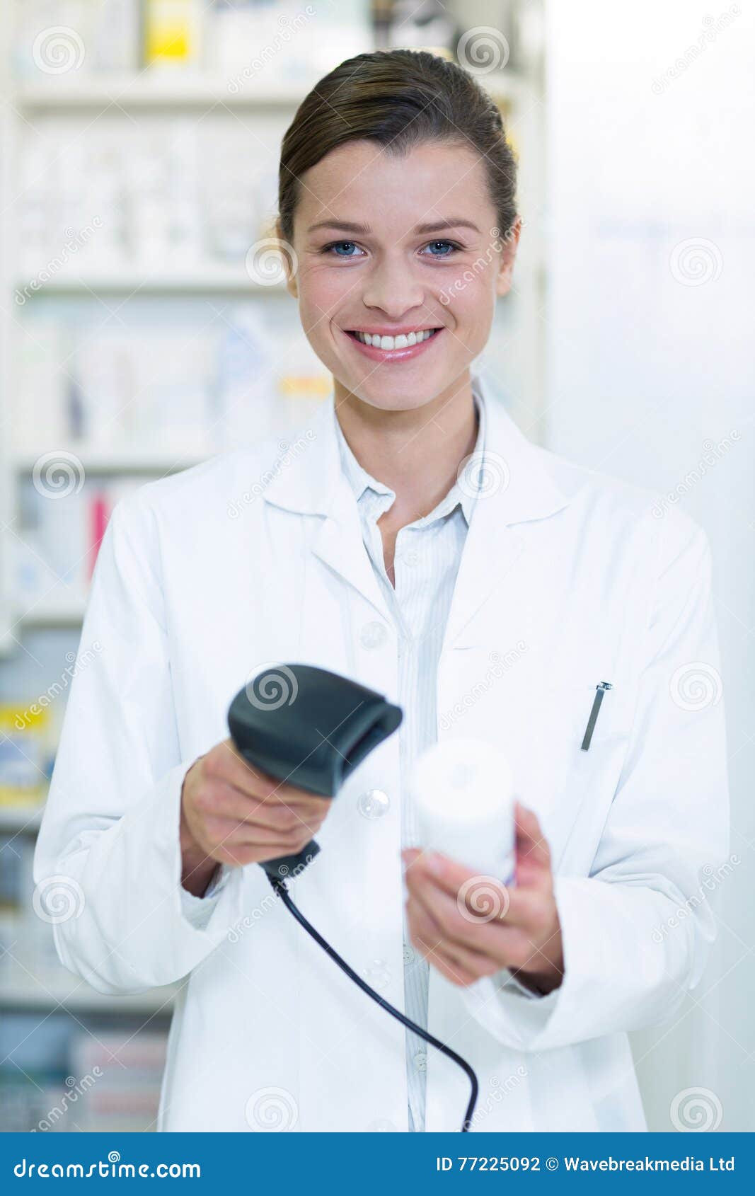Smiling Pharmacist Using Barcode Scanner on Medicine Bottle in Pharmacy
