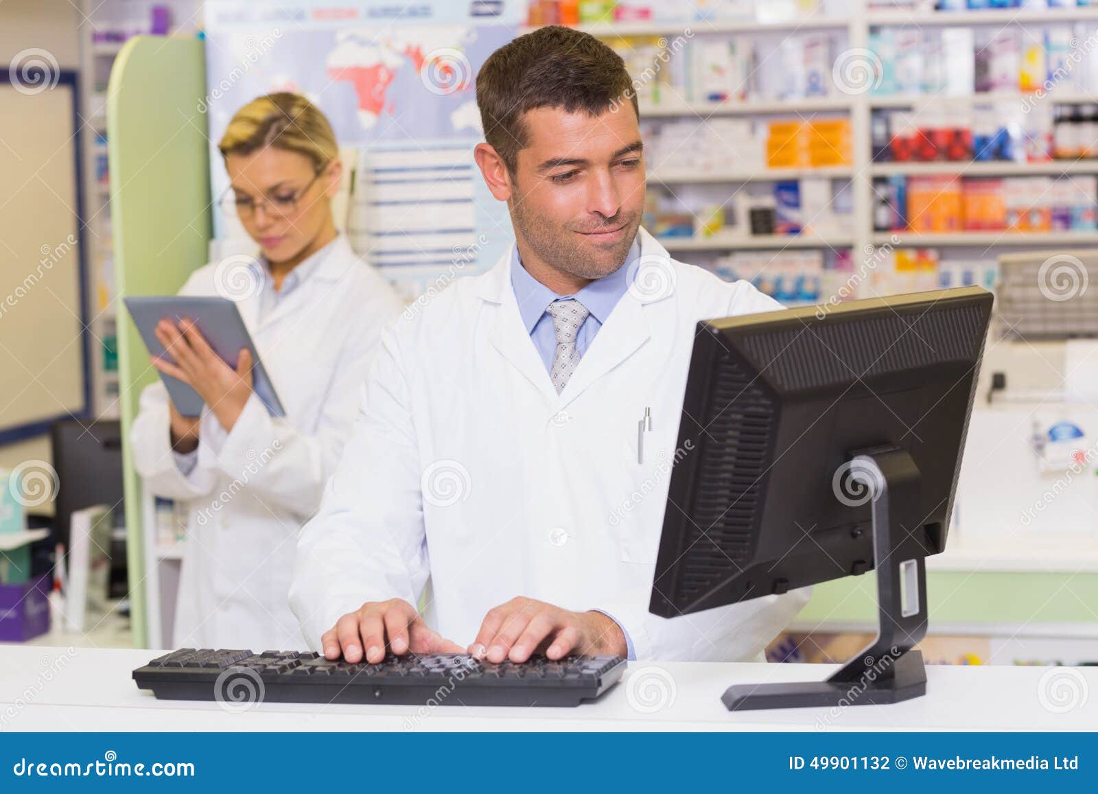 Smiling Pharmacist Using Computer Stock Photo Image of pharmacy