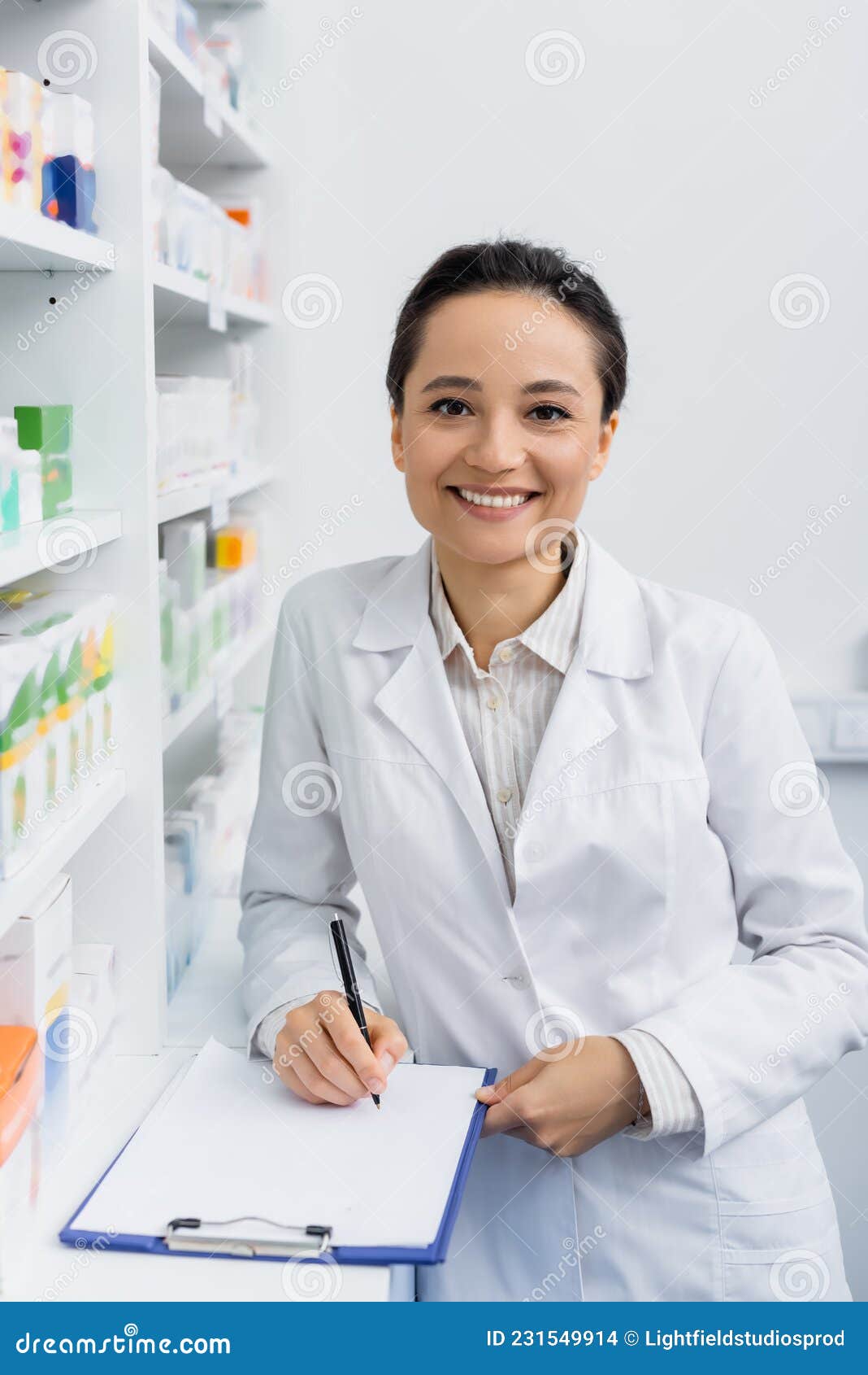 Smiling Pharmacist in White Coat Writing Stock Photo - Image of ...