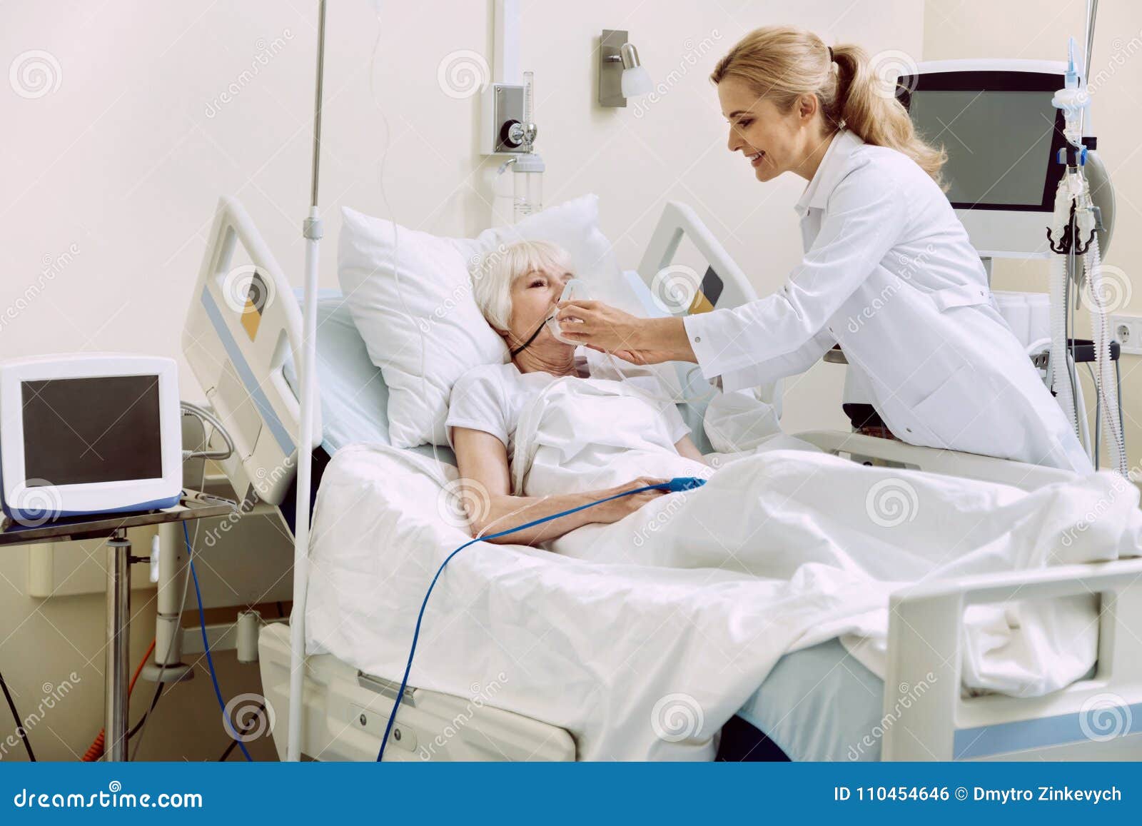 smiling physician adjusting respiratory support at hospital