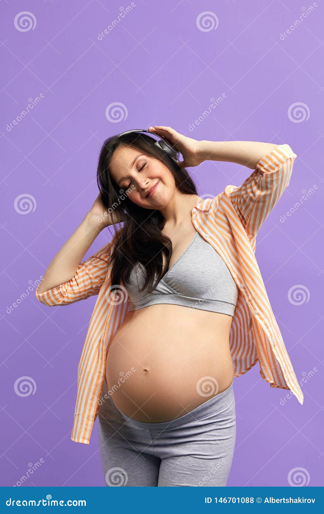 Pregnant woman with headphones on belly, Stock Photo, Picture And Royalty  Free Image. Pic. WR0252878
