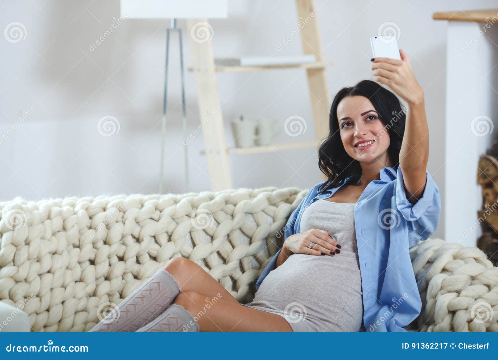 Smiling Pregnant Woman Taking A Self Portrait With Her