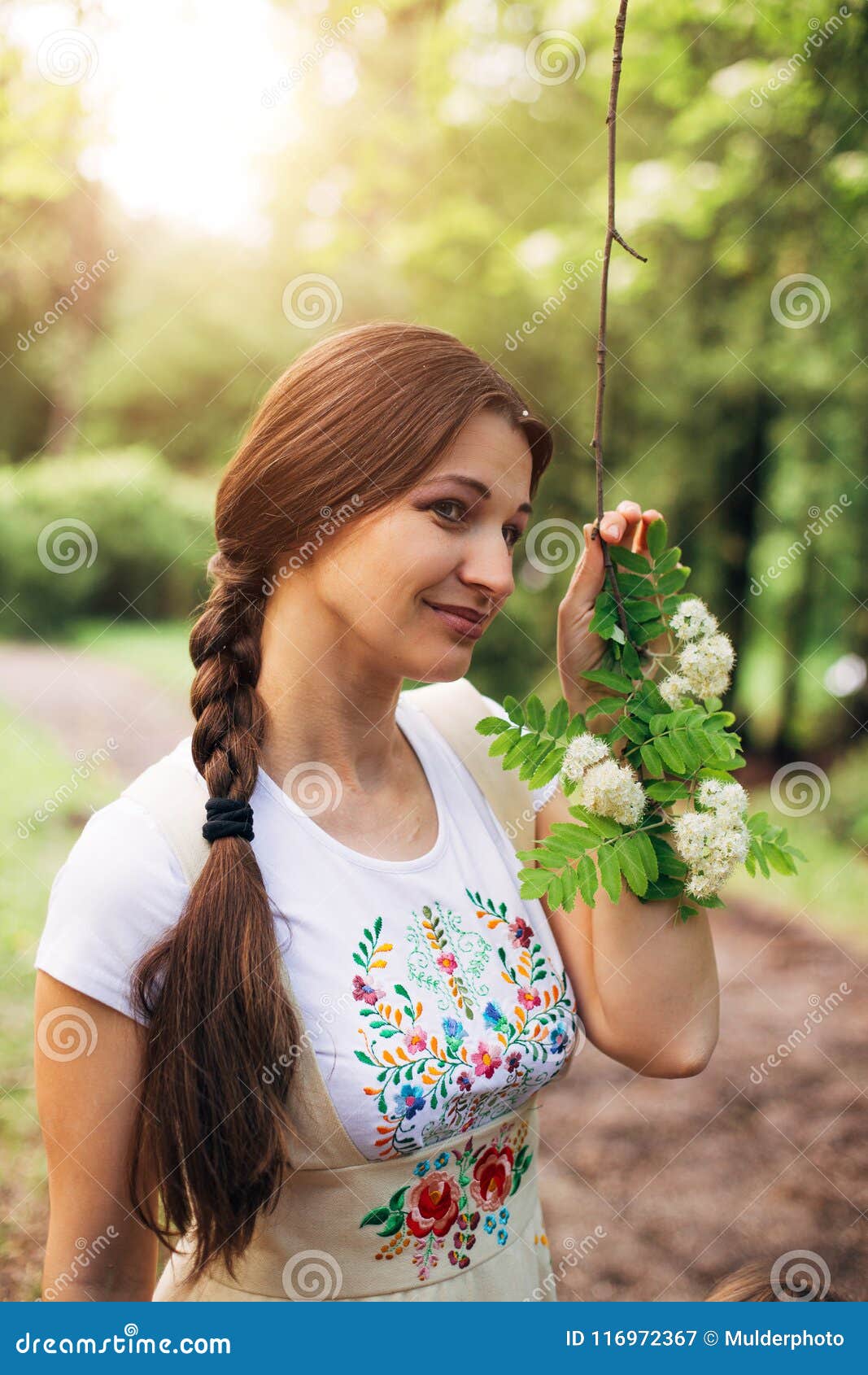 Smiling Pretty Girl in Russian Dress with Embroidery Holding Branch of ...