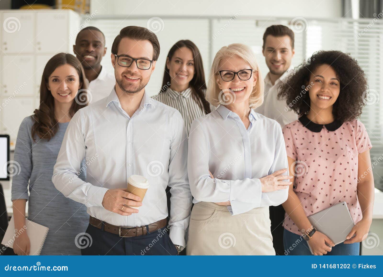 smiling professional business leaders and employees group team portrait