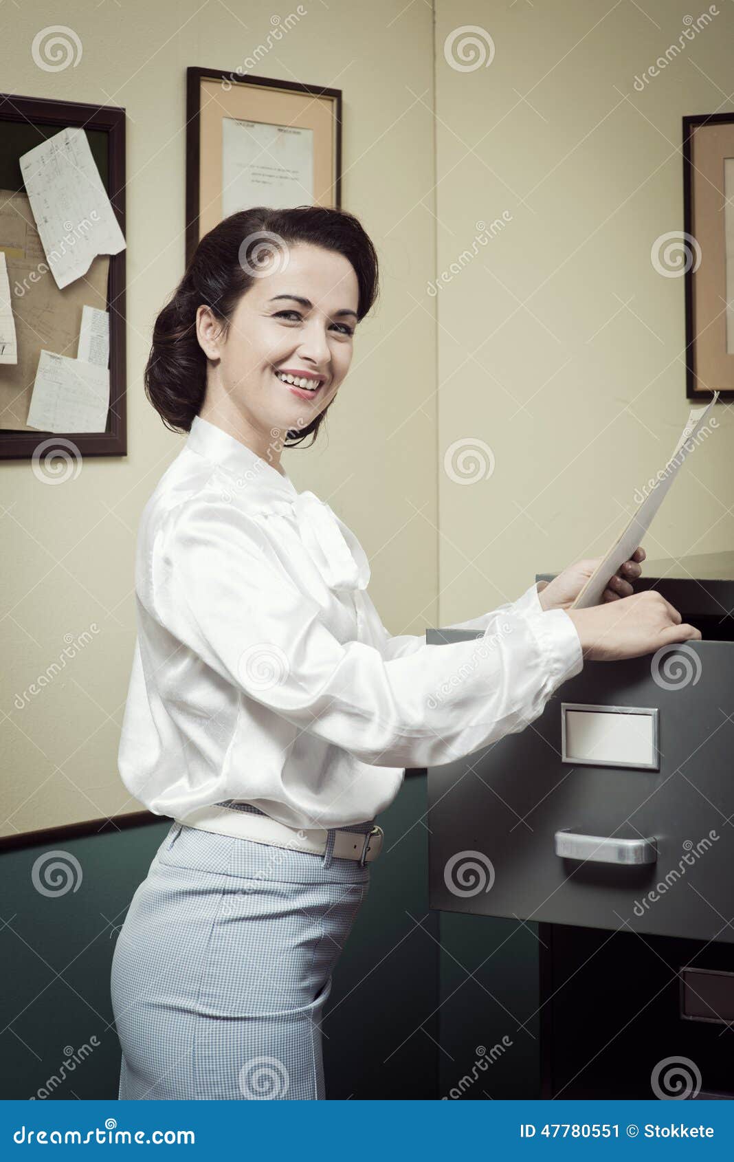 Smiling Secretary Searching Files In The Filing Cabinet 