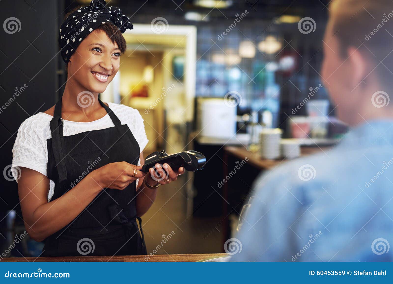 smiling small business owner taking payment