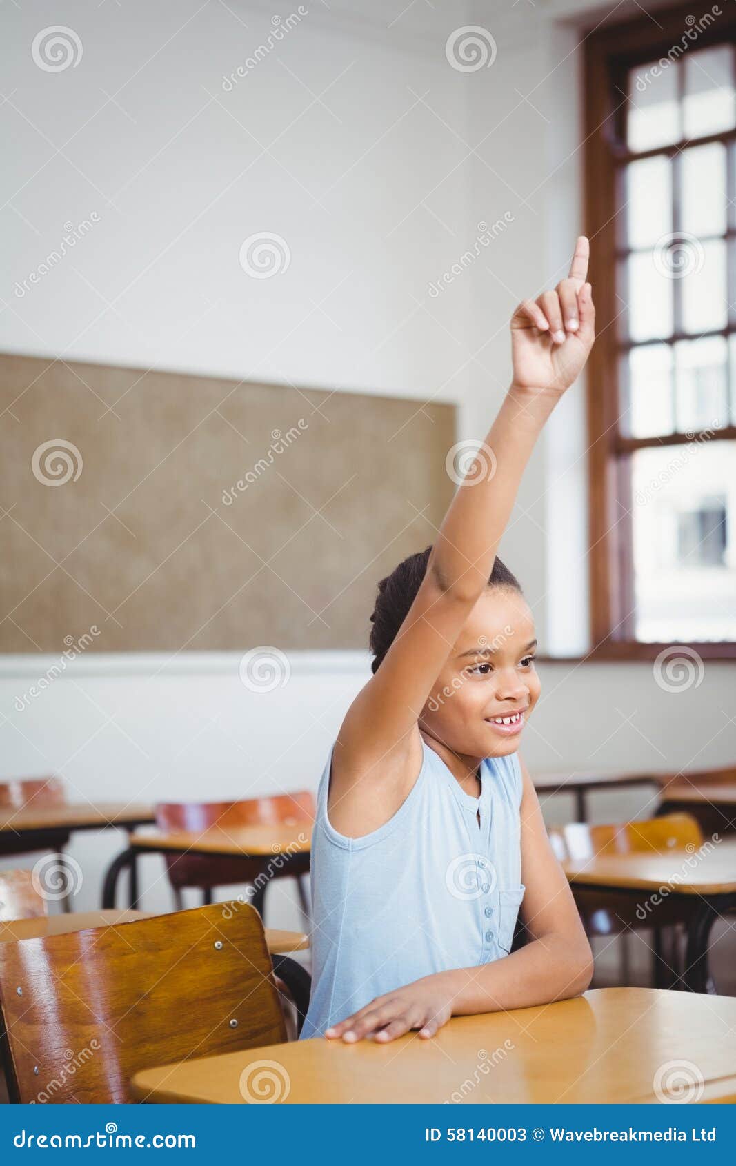 Smiling Student Sitting at a Desk with Raised Arm Stock Image Image