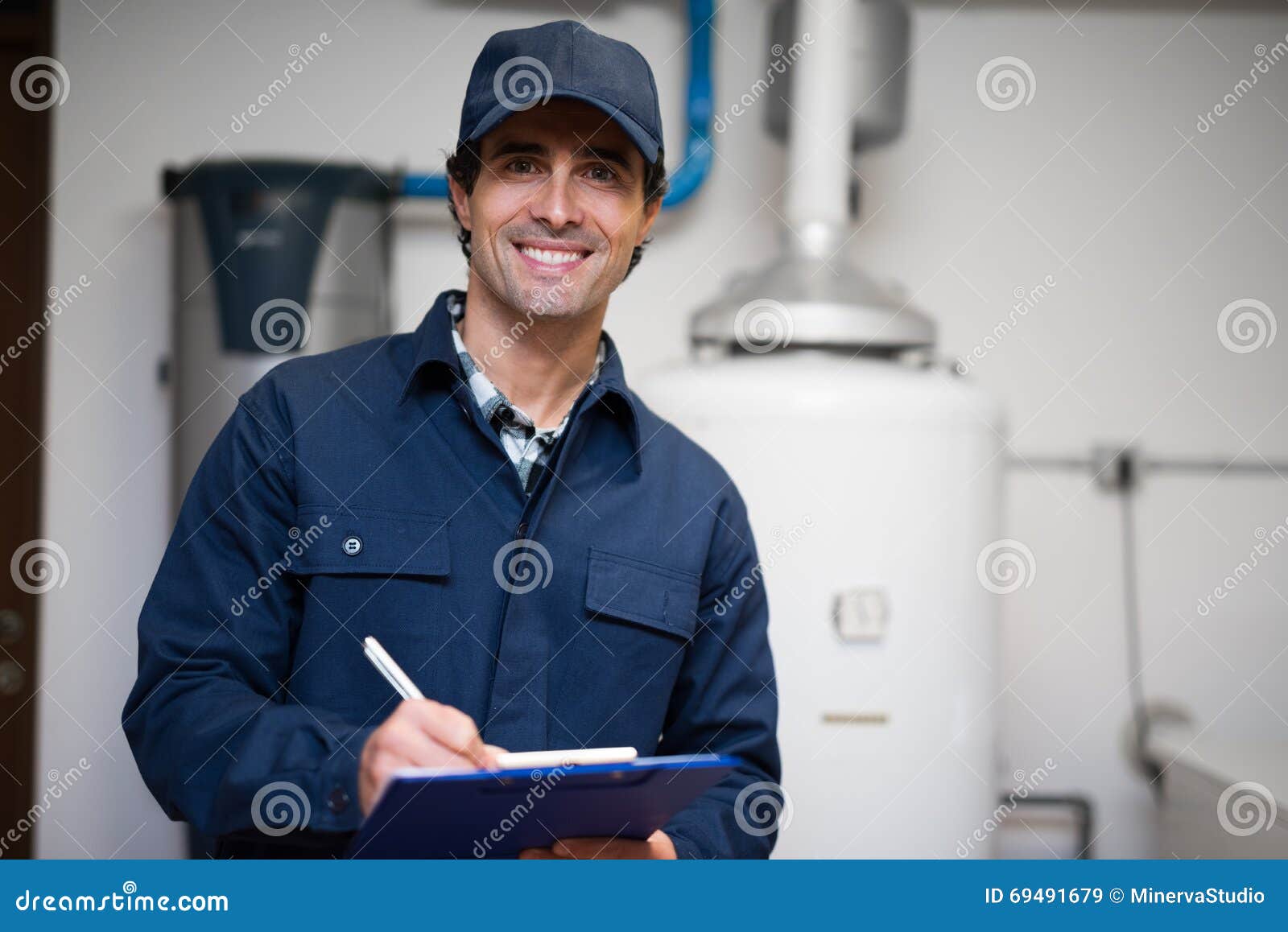 smiling technician servicing an hot-water heater