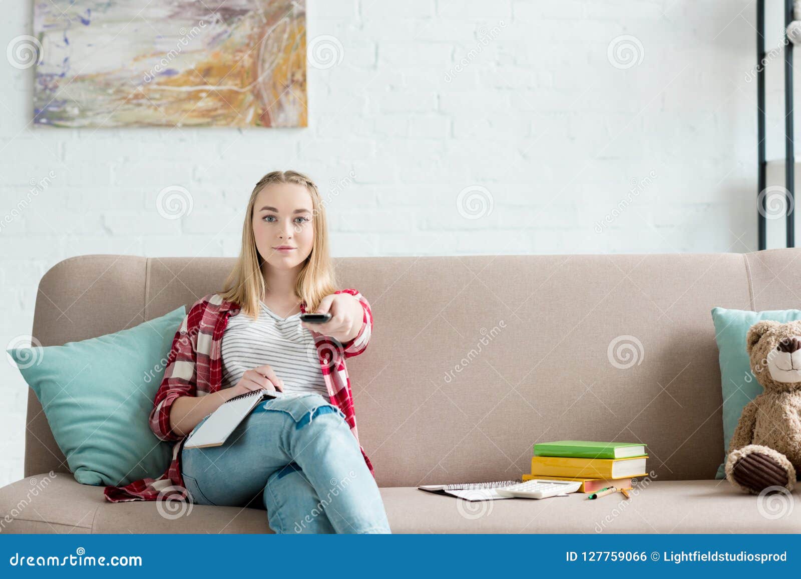 Smiling Teen Student Girl With Remote Control Watching Tv Whil