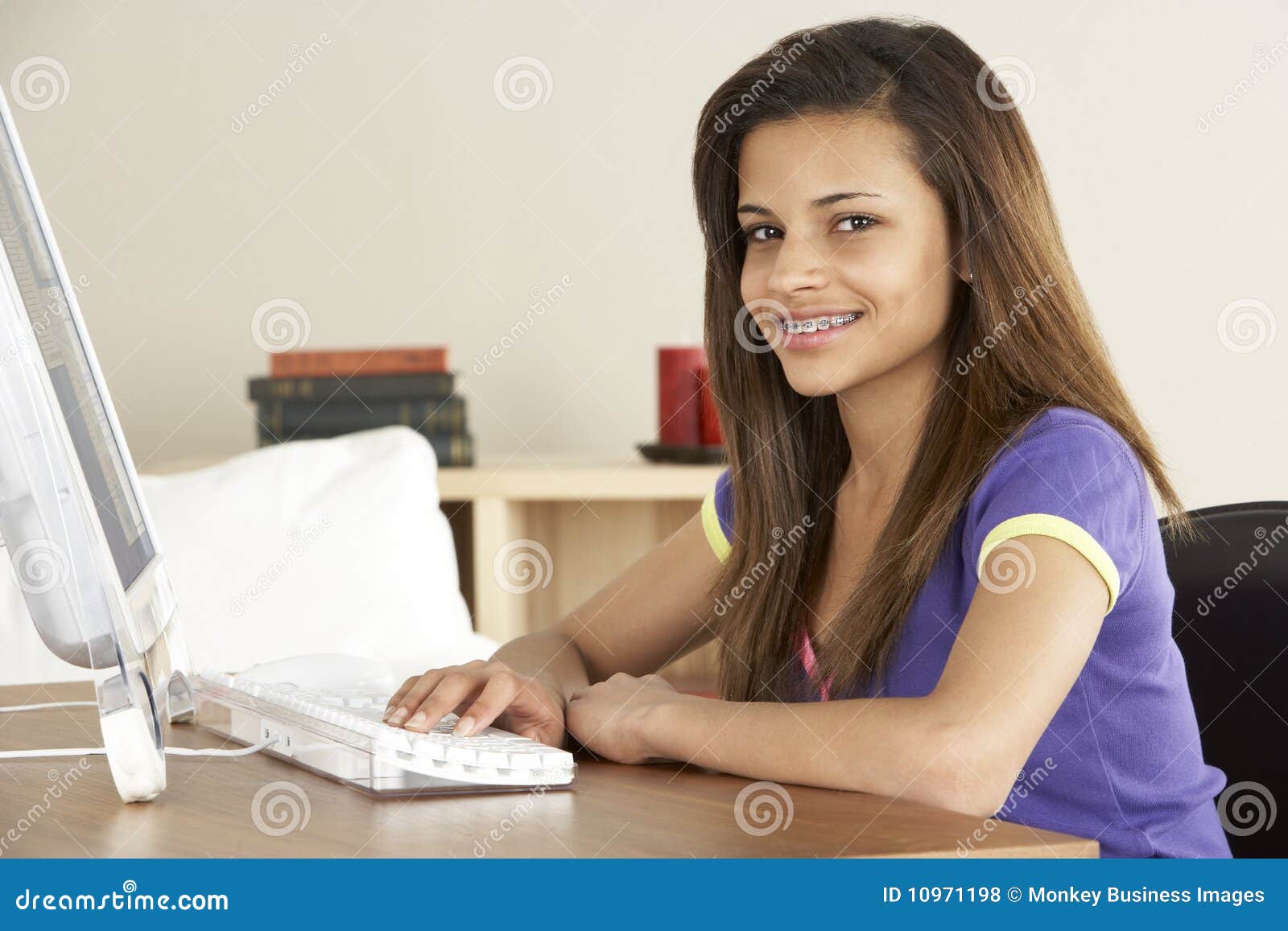 Smiling Teenage Girl On Computer At Home Stock Photo ... Smiling Teenage Girl