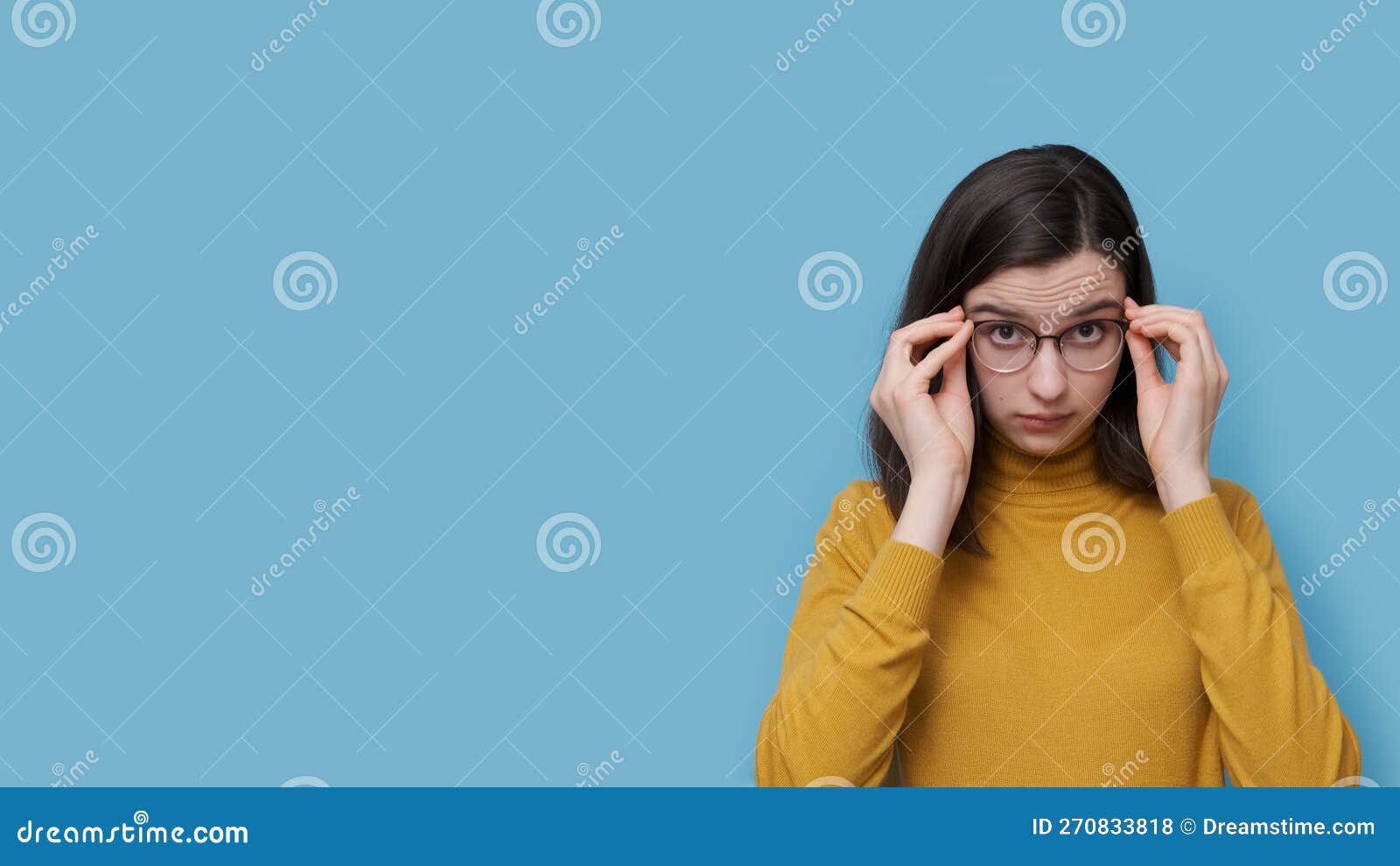 a smiling teenage student girl taking off or putting on glasses. girl sees better as trying new prescribed glasses.