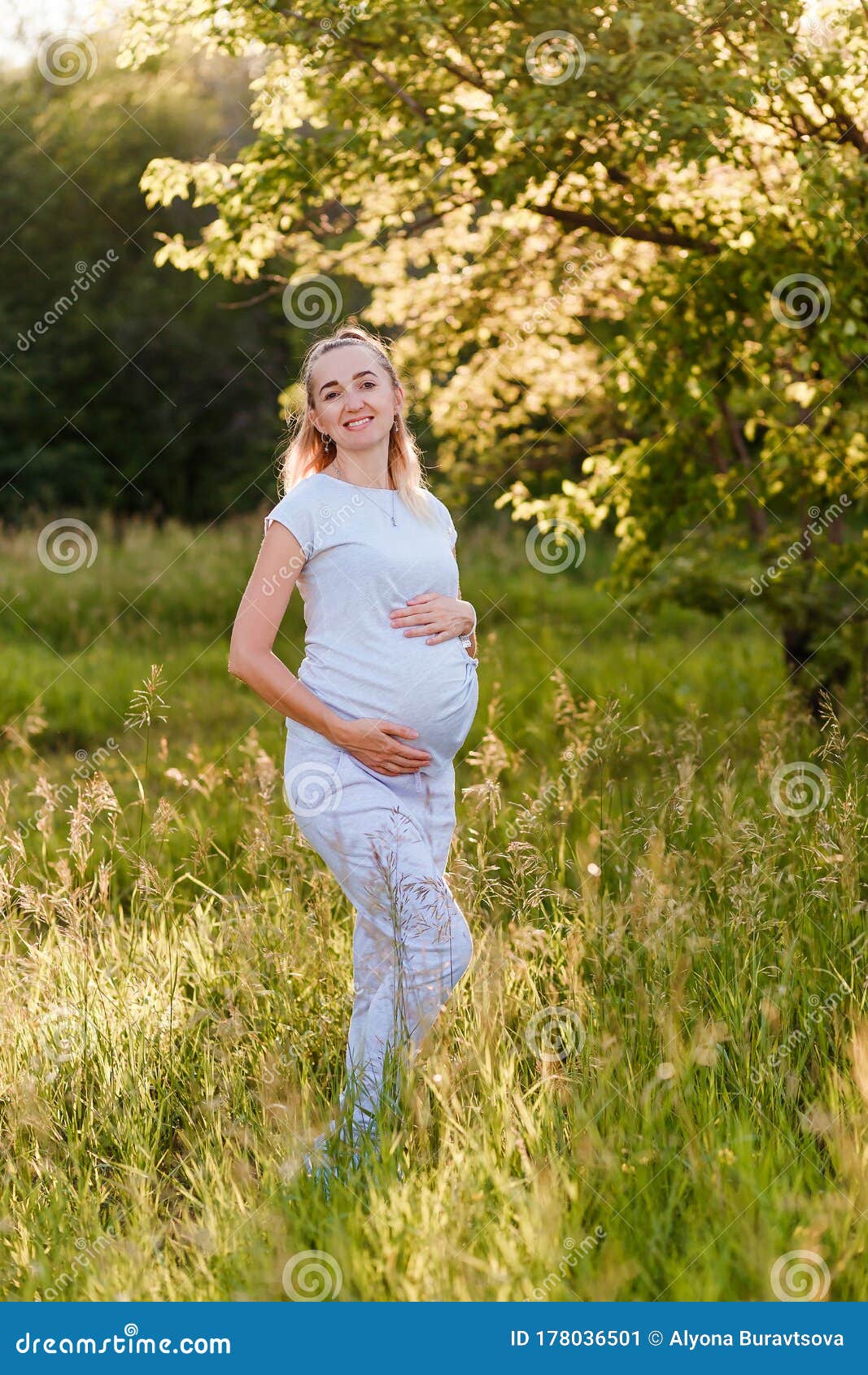 A Smiling Thirty Year Old Pregnant Woman In A Gray T Shirt