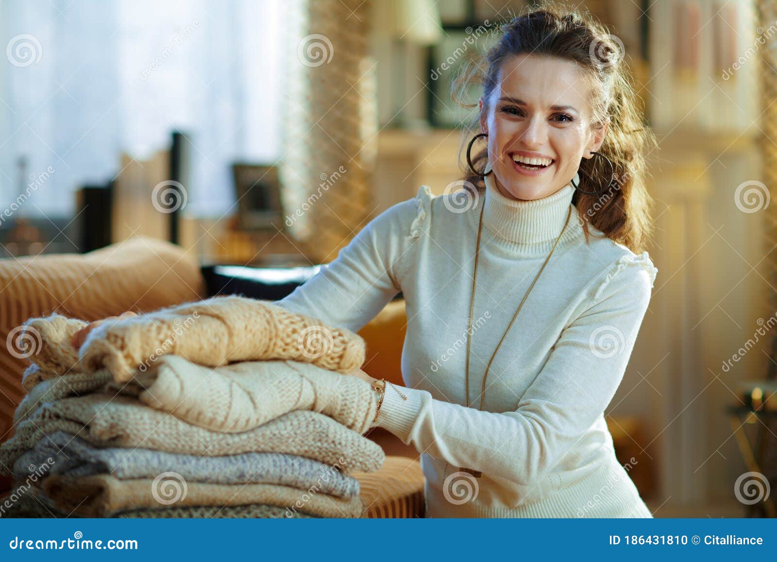 Smiling Trendy Woman Folding Sweaters for Storage Stock Photo - Image ...