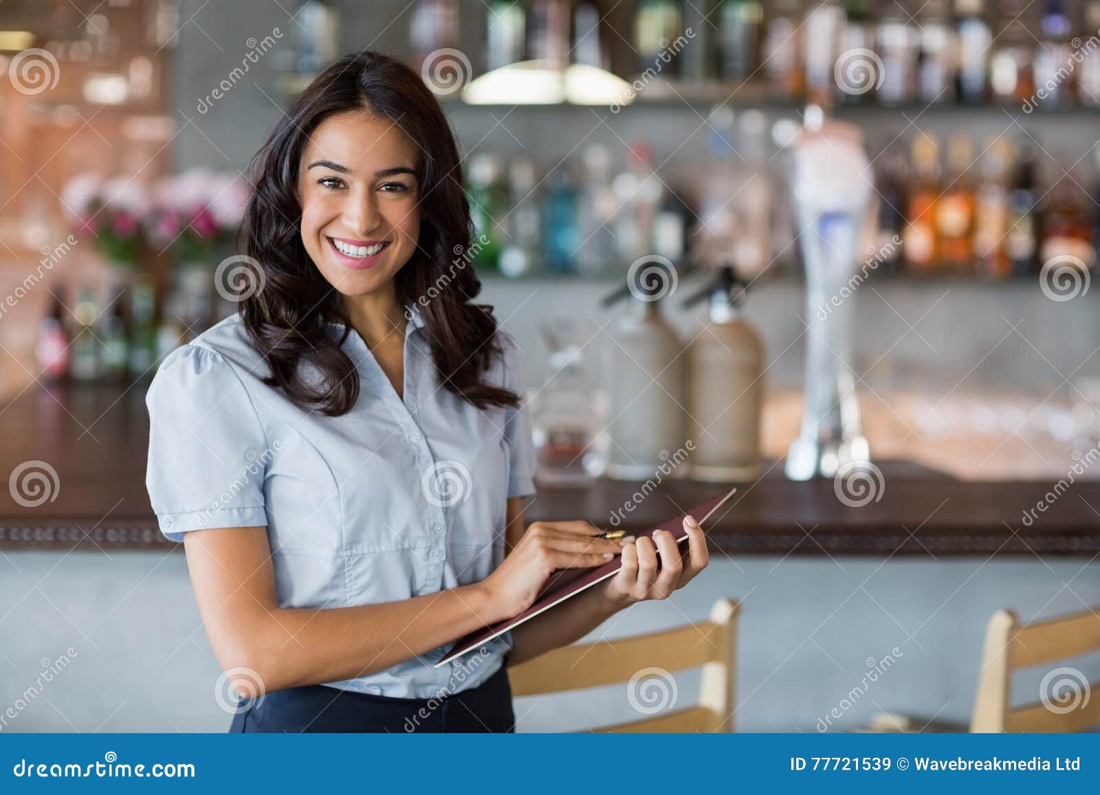 smiling waitress holding a file