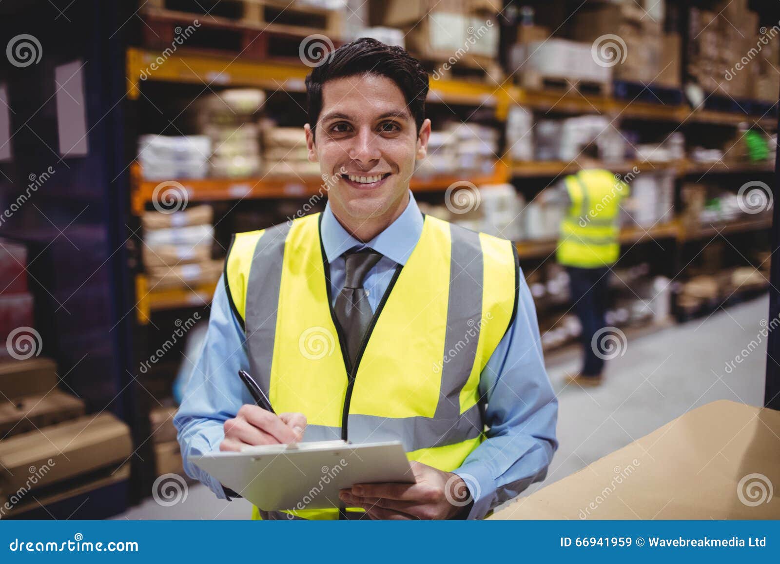 Smiling Warehouse Manager Writing on Clipboard Stock Image Image of