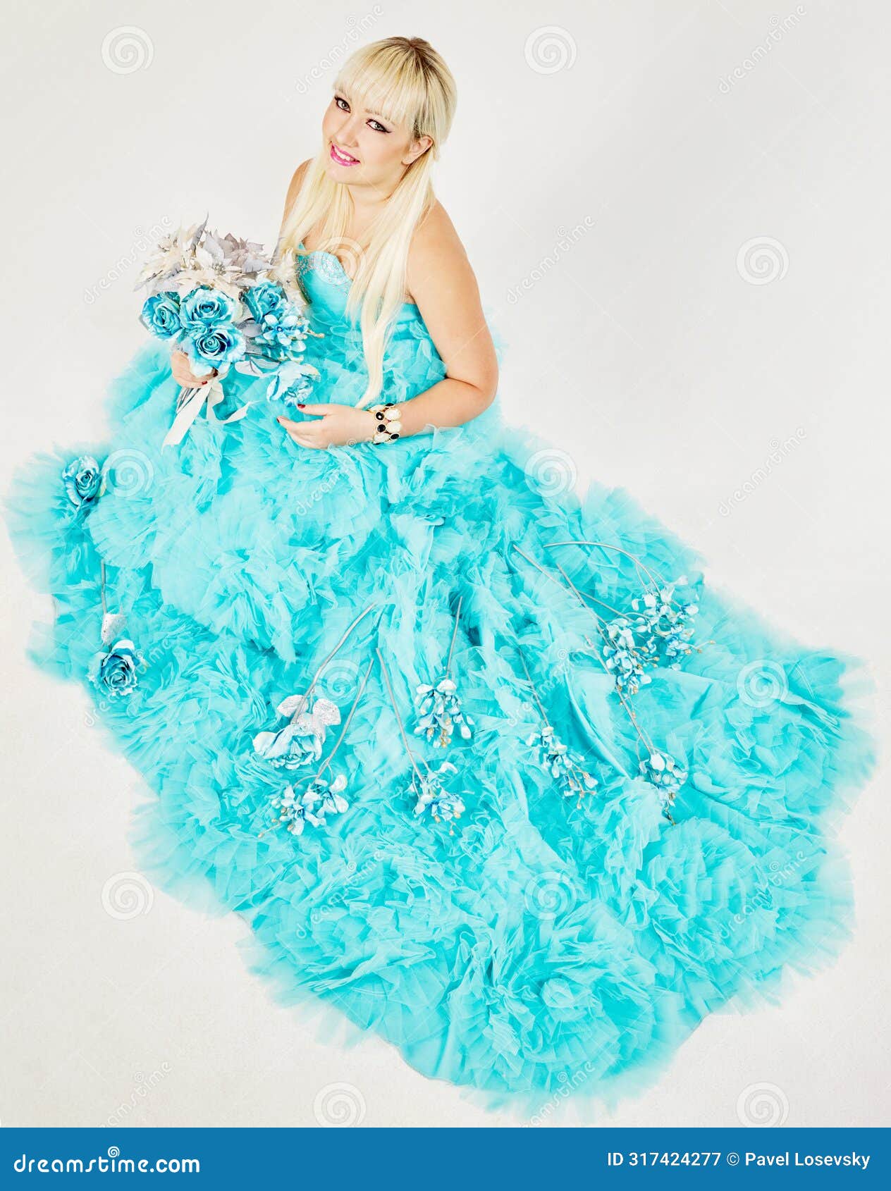 smiling woman in blue fluffy dress with bunch of