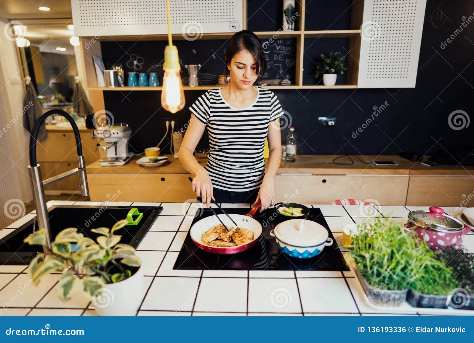 https://thumbs.dreamstime.com/z/smiling-woman-cooking-healthy-meal-home-kitchen-making-dinner-island-standing-induction-hob-preparing-chicken-enjoying-136193336.jpg