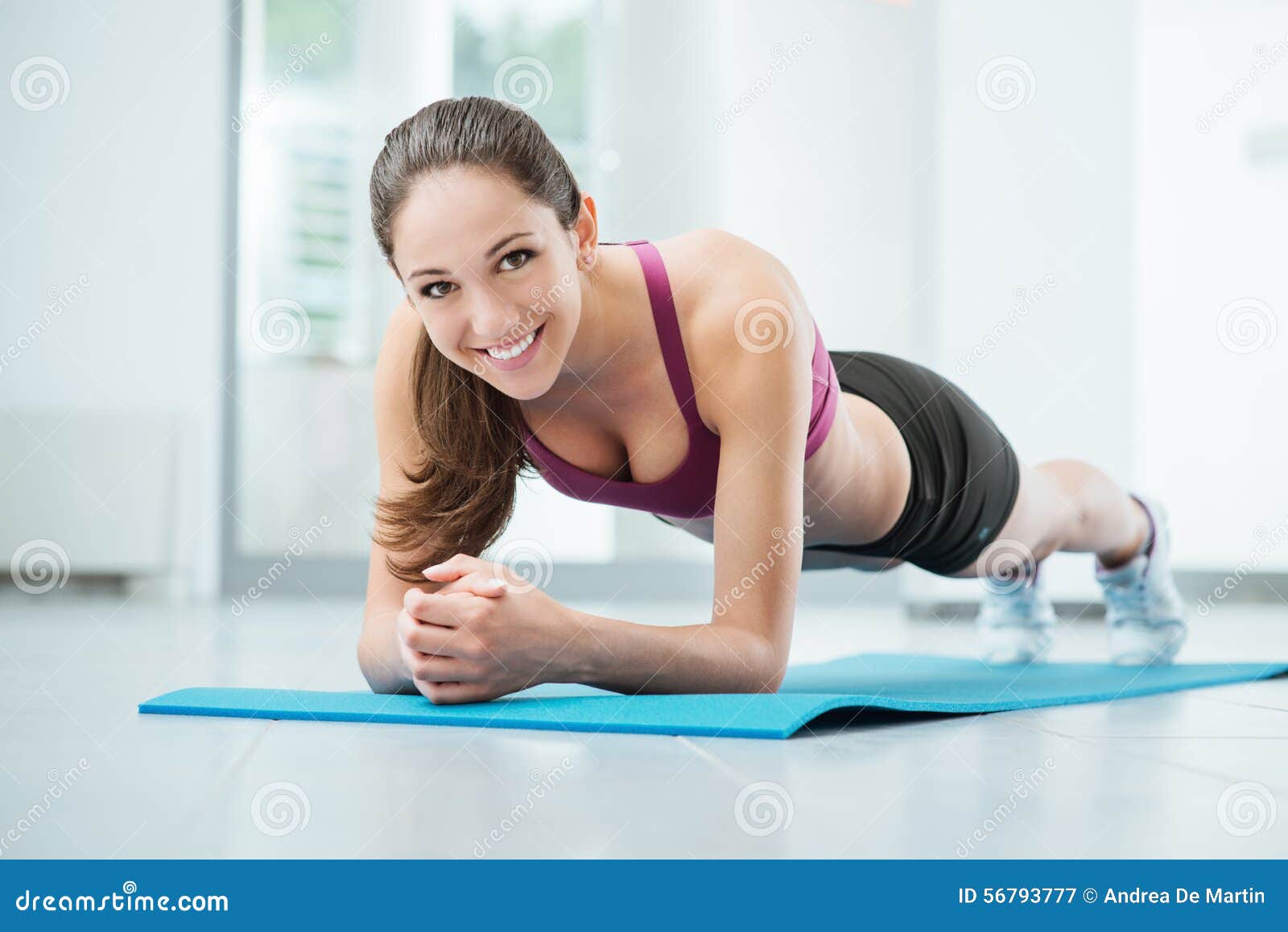 Smiling fitness girl, young athlete sits at home on yoga mat, waves hand at  smartphone, joing online workout training session from home, says hello  Stock Photo - Alamy