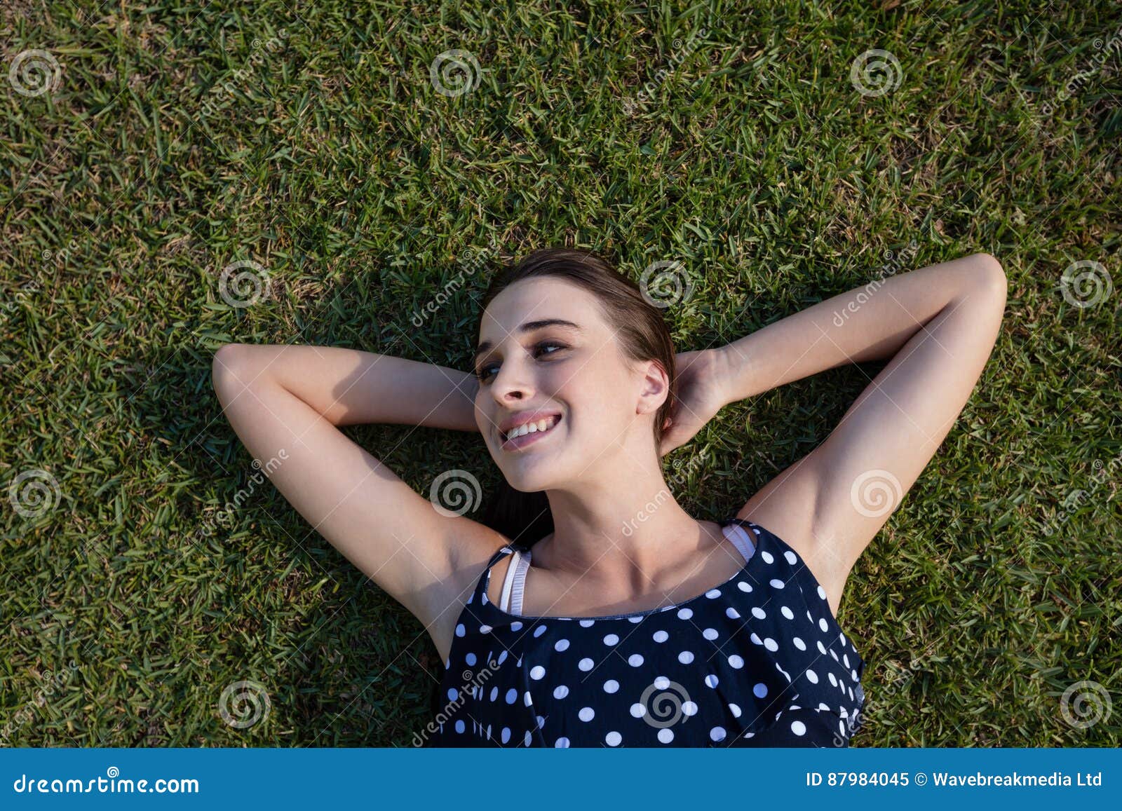 Smiling Woman Lying on Grass with Hands Behind Head Stock Image Image